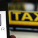 File illustration picture showing the logo of car-sharing service app Uber on a smartphone next to the picture of an official German taxi sign in Frankfurt, September 15, 2014. A Frankfurt court earlier this month instituted a temporary injunction against Uber from offering car-sharing services across Germany. San Francisco-based Uber, which allows users to summon taxi-like services on their smartphones, offers two main services, Uber, its classic low-cost, limousine pick-up service, and Uberpop, a newer ride-sharing service, which connects private drivers to passengers - an established practice in Germany that nonetheless operates in a legal grey area of rules governing commercial transportation. REUTERS/Kai Pfaffenbach/Files (GERMANY - Tags: BUSINESS EMPLOYMENT CRIME LAW TRANSPORT)