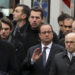French President Francois Hollande, center, flanked with security forces gestures, as he arrives outside the French satirical newspaper Charlie Hebdo's office, in Paris, Wednesday, Jan. 7, 2015. Masked gunmen stormed the offices of a French satirical newspaper Wednesday, killing at least 11 people before escaping, police and a witness said. The weekly has previously drawn condemnation from Muslims. (AP Photo/Remy De La Mauviniere)