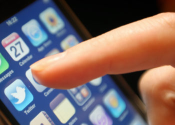 The logo of social networking website Twitter is seen displayed on the screen of an iPhone smartphone.