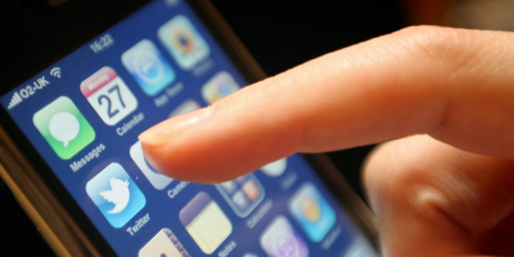 The logo of social networking website Twitter is seen displayed on the screen of an iPhone smartphone.