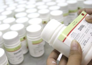 epa000321318 An Indonesian employee of Kimia Farma pharmacy company puts the 'Neviral's' logo onto bottles in Bandung, West Java Indonesia on 30 November 2004. 'Nerival' is a medicine for HIV patients. Kimia Farma pharmacy produce more than 4,8 millions 'Nerival' pills per year and distribute them to many hospitals for treat more than 100,000 HIV/ AIDS patients in Indonesia. The Joint United Nations Program on HIV/ AIDS (UNAIDS) warned Indonesia on Tuesday that the virus was spreading rapidly among women and girls in the country. The number of people living with HIV/ AIDS in the country is between 90,000 and 135,000, according to UNAIDS. EPA/BAGUS INDAHONO