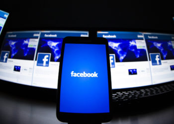 The loading screen of the Facebook application on a mobile phone is seen in this photo illustration taken in Lavigny May 16, 2012. Facebook Inc increased the size of its initial public offering by almost 25 percent, and could raise as much as $16 billion as strong investor demand for a share of the No.1 social network trumps debate about its long-term potential to make money. Facebook, founded eight years ago by Mark Zuckerberg in a Harvard dorm room, said on Wednesday it will add about 84 million shares to its IPO, floating about 421 million shares in an offering expected to be priced on Thursday. REUTERS/Valentin Flauraud (SWITZERLAND - Tags: BUSINESS SCIENCE TECHNOLOGY SOCIETY TPX IMAGES OF THE DAY) - RTR325LC