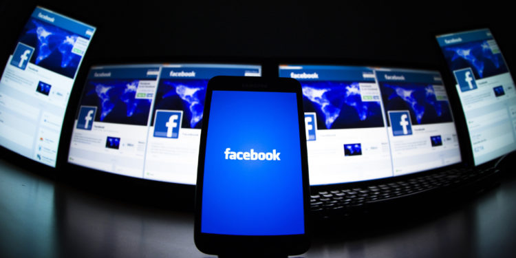 The loading screen of the Facebook application on a mobile phone is seen in this photo illustration taken in Lavigny May 16, 2012. Facebook Inc increased the size of its initial public offering by almost 25 percent, and could raise as much as $16 billion as strong investor demand for a share of the No.1 social network trumps debate about its long-term potential to make money. Facebook, founded eight years ago by Mark Zuckerberg in a Harvard dorm room, said on Wednesday it will add about 84 million shares to its IPO, floating about 421 million shares in an offering expected to be priced on Thursday. REUTERS/Valentin Flauraud (SWITZERLAND - Tags: BUSINESS SCIENCE TECHNOLOGY SOCIETY TPX IMAGES OF THE DAY) - RTR325LC