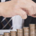 Business women put coin stack money for money growth concept
