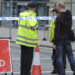 Police block a road near to the Manchester Arena in central Manchester, England Tuesday, May 23, 2017. An explosion struck an Ariana Grande concert attended by thousands of young music fans in northern England late Monday, killing over a dozen people and injuring dozens in what police said Tuesday was being treated as a terrorist attack. (AP Photo/Rui Vieira)