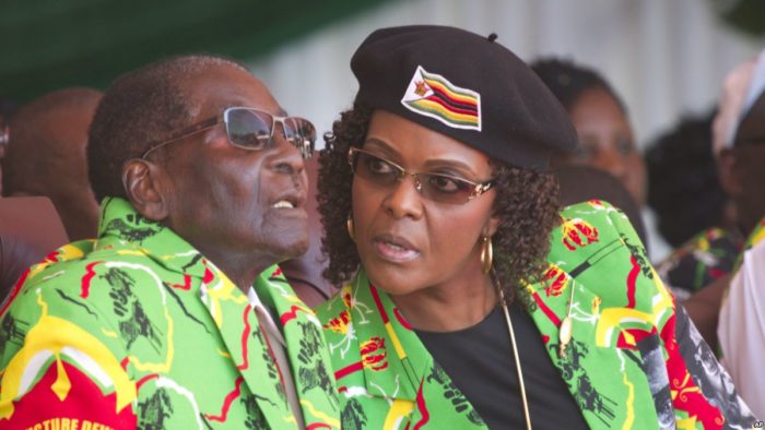 Zimbabwean President Robert Mugabe and his wife Grace follow proceedings during a youth rally in Marondera about 100 kilometres east of Harare, Friday, June, 2, 2017.The rally was held as part of his 2017 Presidential election campaign bid where the youth declared Mugabe as the sole candidate and life President of the Southern African nation.(AP Photo/Tsvangirayi Mukwazhi)