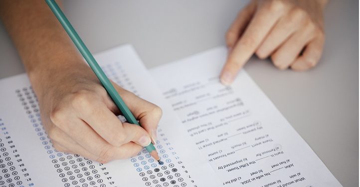 Close up of hands of student doing test.