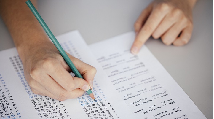 Close up of hands of student doing test.