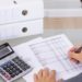 Business man accountant calculating invoices in office