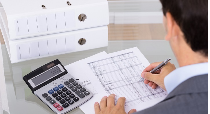 Business man accountant calculating invoices in office