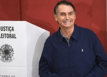 Brazil's right-wing presidential candidate for the Social Liberal Party (PSL) Jair Bolsonaro smiles after casting his vote during general elections, in Rio de Janeiro, Brazil, on October 7, 2018.
Polling stations opened in Brazil on Sunday for the most divisive presidential election in the country in years, with far-right lawmaker Jair Bolsonaro the clear favorite in the first round. About 147 million voters are eligible to cast ballots and choose who will rule the world's eighth biggest economy. New federal and state legislatures will also be elected. / AFP PHOTO / Mauro Pimentel